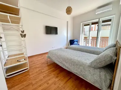 a living room with two beds and a tv at Roma Lux Apartment Lorenzo in Rome