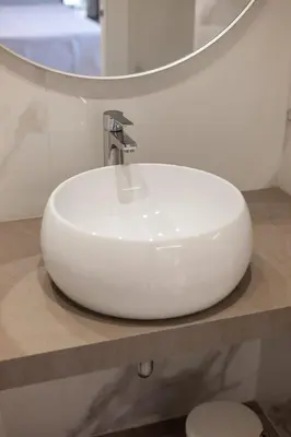a white sink in a bathroom with a mirror at Koala House in Rome