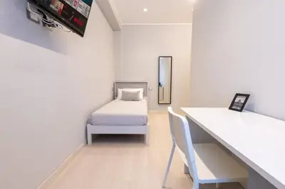 a small room with a bed and a desk with a table at Koala House in Rome
