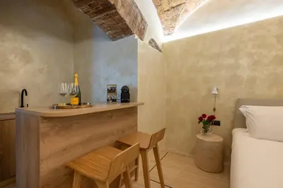 a bedroom with a bed and a table and chairs at Trastevere Urbes Collection in Rome