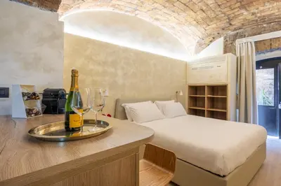 a bedroom with a bed and a bottle of champagne at Trastevere Urbes Collection in Rome