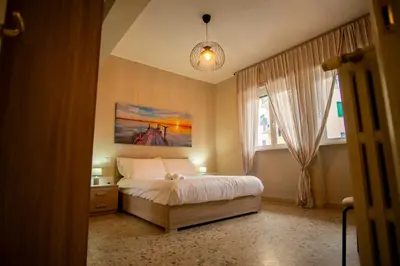 a bedroom with a bed and a painting on the wall at Vatican Comfortable 5 Bedroom Flat - 6 min METRO A by ORPI RENT in Rome