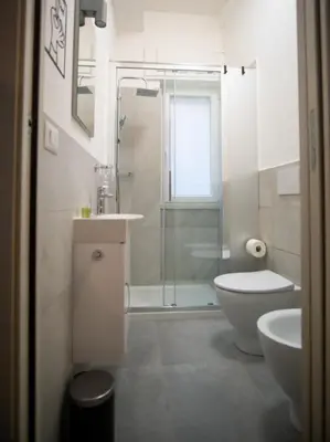 a bathroom with a shower and a toilet and a sink at Vatican Comfortable 5 Bedroom Flat - 6 min METRO A by ORPI RENT in Rome