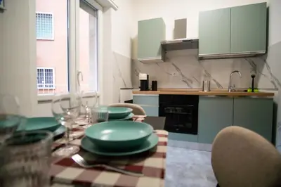 a kitchen with a table with green plates on it at Vatican Comfortable 5 Bedroom Flat - 6 min METRO A by ORPI RENT in Rome