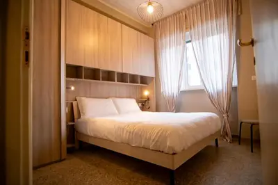 a bedroom with a large bed and a window at Vatican Comfortable 5 Bedroom Flat - 6 min METRO A by ORPI RENT in Rome