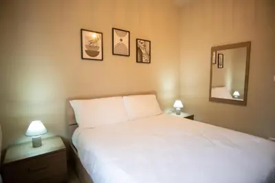 a bedroom with a white bed and three pictures on the wall at Vatican Comfortable 5 Bedroom Flat - 6 min METRO A by ORPI RENT in Rome