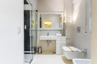 a bathroom with a toilet and a sink and a mirror at Art Maison Porta Portese, 10 min from Trastevere in Rome