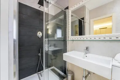 a bathroom with a shower and a sink and a mirror at Art Maison Porta Portese, 10 min from Trastevere in Rome