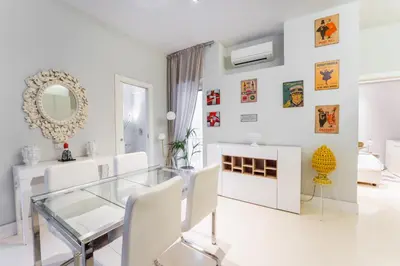 a white dining room with a glass table and white chairs at Art Maison Porta Portese, 10 min from Trastevere in Rome