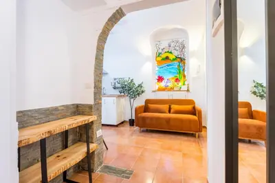 a living room with a couch and a table at Archetto Loft, Cozy and Cute Place in Trastevere in Rome
