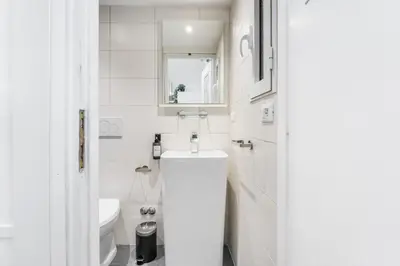 a white bathroom with a sink and a toilet at Archetto Loft, Cozy and Cute Place in Trastevere in Rome