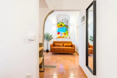 a living room with a couch and a mirror at Archetto Loft, Cozy and Cute Place in Trastevere in Rome