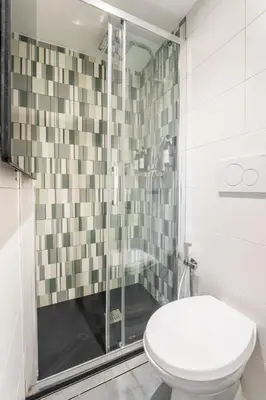 a bathroom with a toilet and a glass shower at Archetto Loft, Cozy and Cute Place in Trastevere in Rome