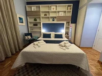 a bedroom with a large bed with two towels on it at Room 55 Testaccio in Rome