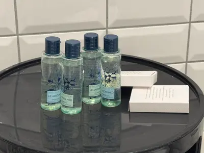 a group of four bottles sitting on a glass table at Room 55 Testaccio in Rome