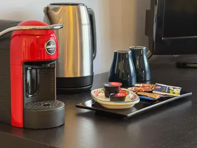 a red coffee maker on a counter next to a toaster at Room 55 Testaccio in Rome