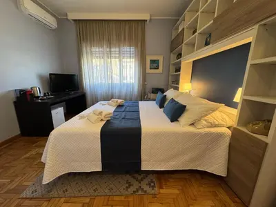 a bedroom with a large bed and a television at Room 55 Testaccio in Rome