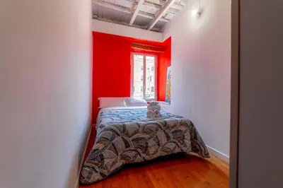a bedroom with red walls and a bed with a teddy bear on it at Casa Vanvitelli - Testaccio in Rome