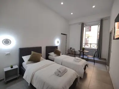 a bedroom with three beds with white sheets at Lifestyle 168 Guest House in Rome
