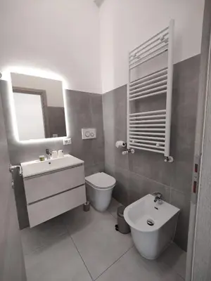 a bathroom with a sink and a toilet and a mirror at Lifestyle 168 Guest House in Rome
