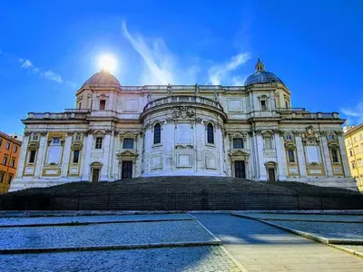 a large white building with the sun behind it at Lifestyle 168 Guest House in Rome