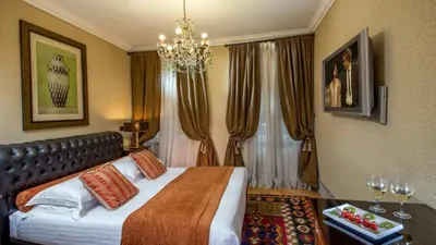 a hotel room with a bed and a chandelier at The Inn at the Roman Forum Autograph Collection - The Inn At The Roman Forum Holidays in Rome