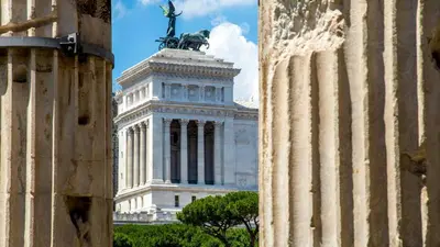 a large building with a statue on top of it at The Inn at the Roman Forum Autograph Collection - The Inn At The Roman Forum Holidays in Rome