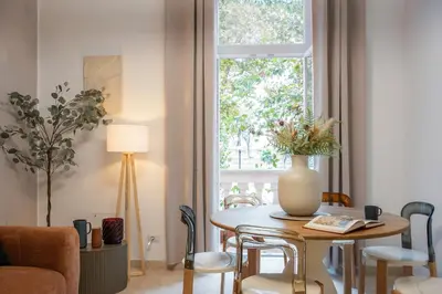 a living room with a table and a window at BruSilva al Colosseo in Rome