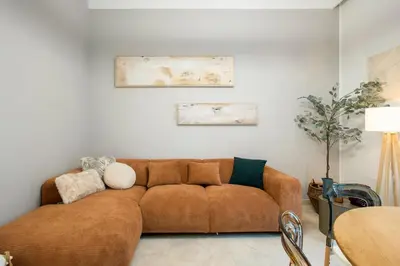a living room with a brown couch in a room at BruSilva al Colosseo in Rome