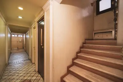 an empty hallway with stairs in a building at Trevi Fountain by BuddyRent in Rome