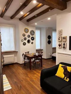 a living room with a table and a couch at Casetta del Bassotto in Rome