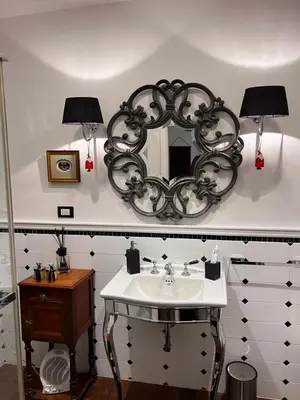 a bathroom with a sink and a mirror on the wall at Casetta del Bassotto in Rome