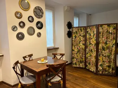 a dining room with a table and plates on the wall at Casetta del Bassotto in Rome