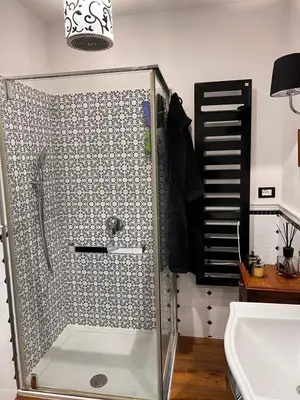a shower with a glass door in a bathroom at Casetta del Bassotto in Rome