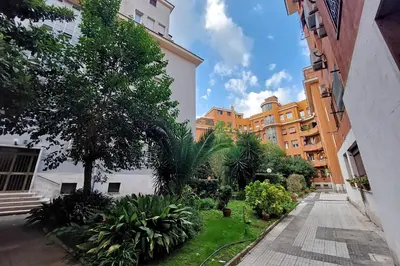 a courtyard of a building with trees and plants at The Place Gallia in Rome