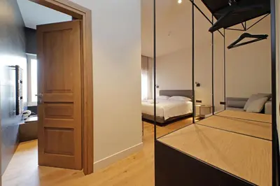 a room with a bedroom with a bed and a mirror at The Place Gallia in Rome