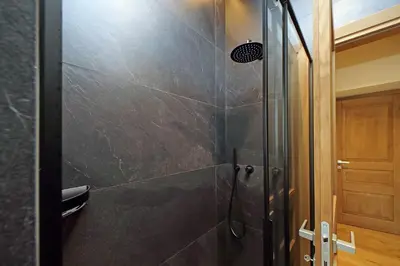 a bathroom with a shower with a glass door at The Place Gallia in Rome
