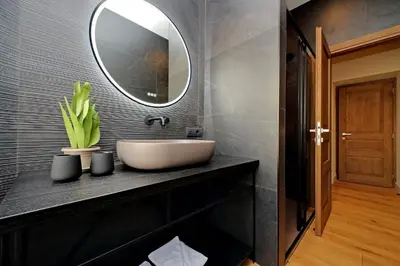 a bathroom with a sink and a mirror at The Place Gallia in Rome