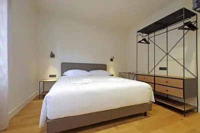 a bedroom with a large white bed and two tables at The Place Gallia in Rome