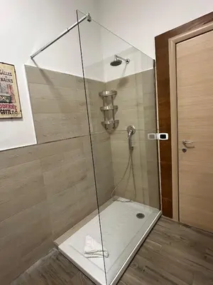 a shower with a glass door in a bathroom at Planny Apartment - Vaticano in Rome