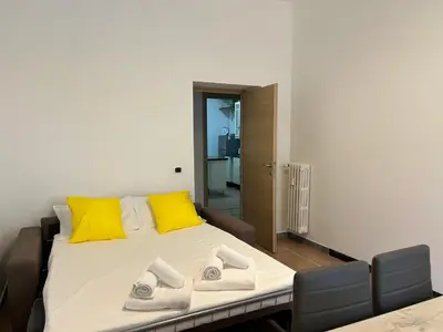 a bedroom with a bed with yellow and gray pillows at Planny Apartment - Vaticano in Rome