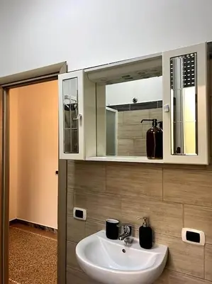 a bathroom with a sink and a mirror at Planny Apartment - Vaticano in Rome