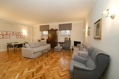 a living room with two couches and a dining room at Castel Sant'Angelo by BuddyRent in Rome