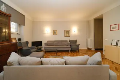 a living room with a couch and a tv at Castel Sant'Angelo by BuddyRent in Rome
