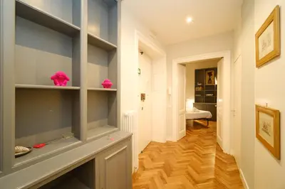 a hallway with wooden floors and shelves in a room at Castel Sant'Angelo by BuddyRent in Rome