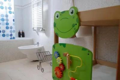 a bathroom with a green dinosaur head on the wall at Olimpico Apartment in Rome