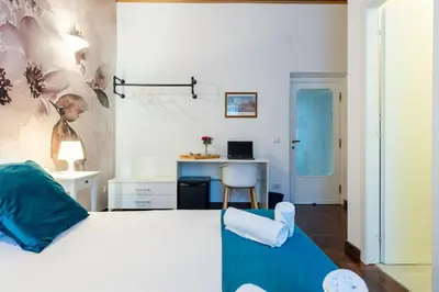 a bedroom with a bed and a desk with a chair at Fantastic Rome Guest House in Rome