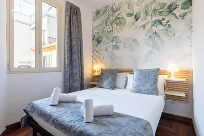 a bedroom with two beds and a window at Fantastic Rome Guest House in Rome