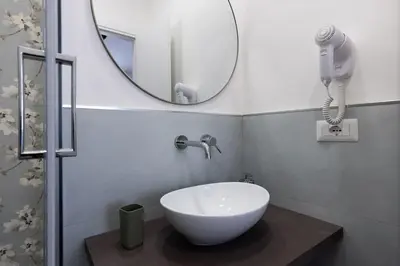 a bathroom with a bowl sink and a mirror at Fantastic Rome Guest House in Rome