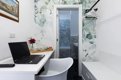 a laptop computer sitting on a desk in a bathroom at Fantastic Rome Guest House in Rome